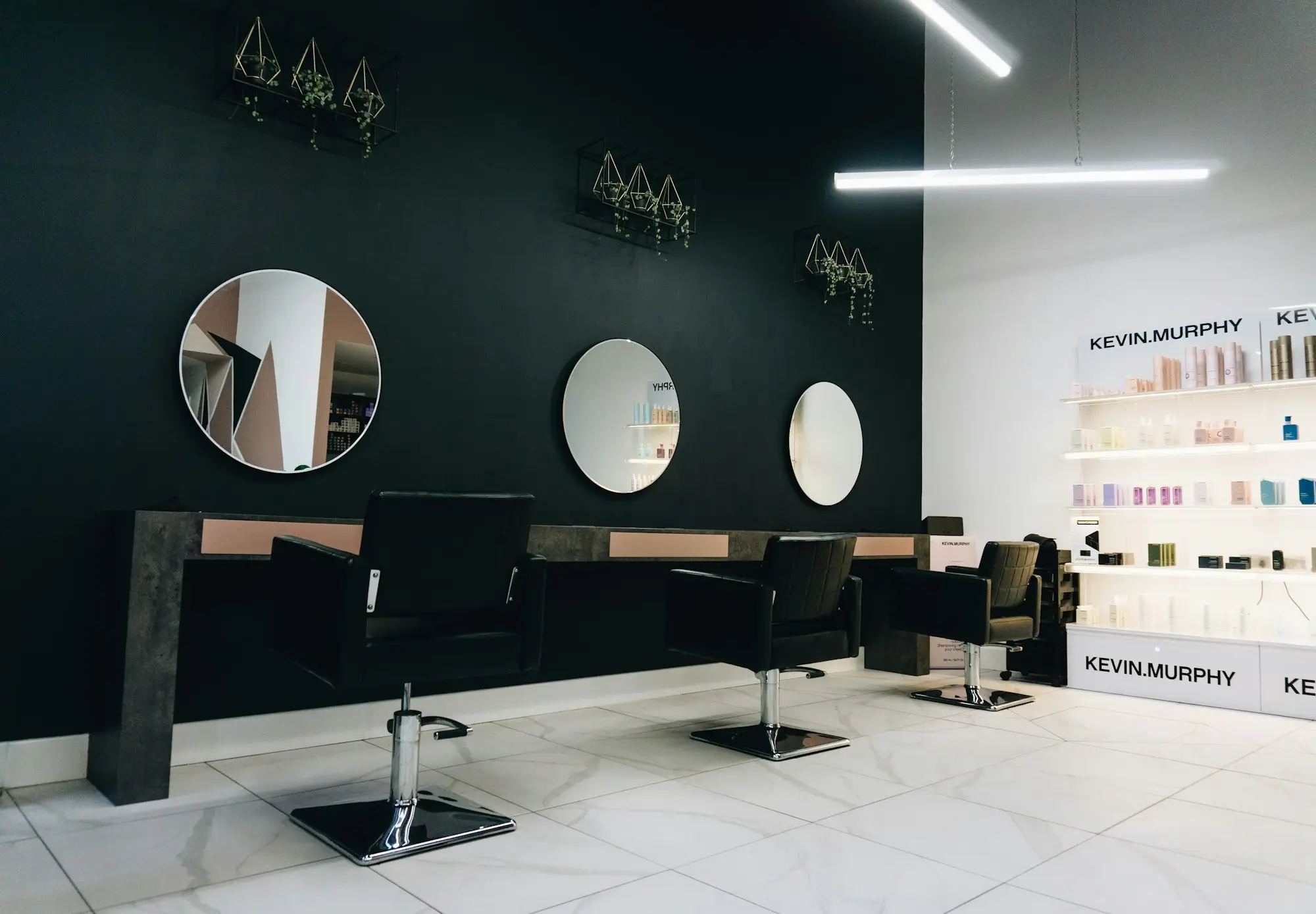 Interior luminoso de una peluquería con sillones, espejos y buena iluminación: peluquería y estética en Santa Isabel (Zaragoza)